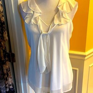 Ivory sleeveless ruffled collar top. Never worn.